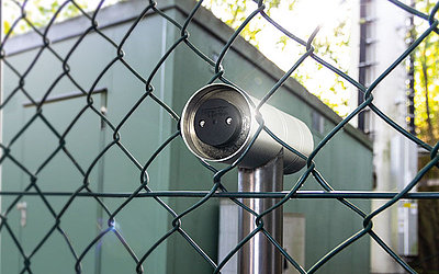 digital safe behind wire mesh fence