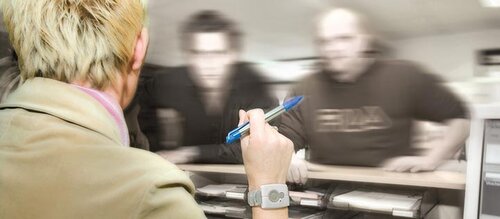 Frau an Empfang wird von zwei Männern bedroht