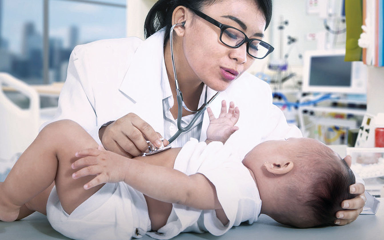 Nurse examining baby
