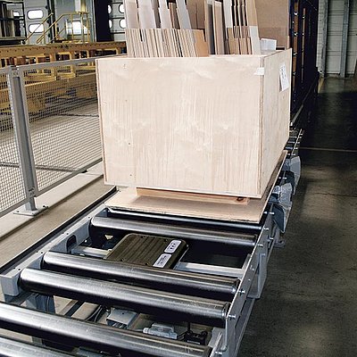 Wooden box on large conveyor belt