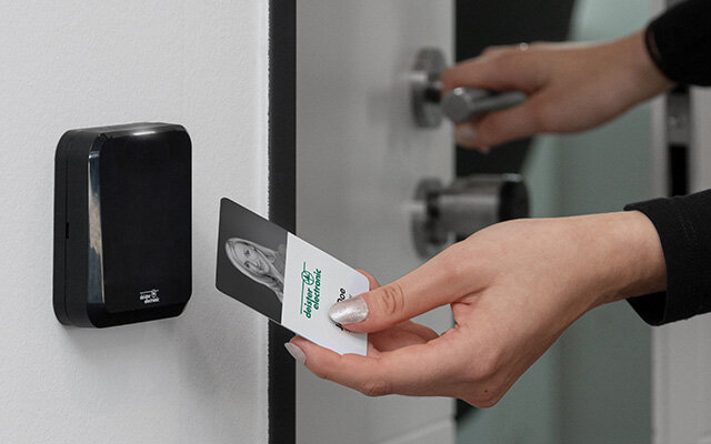 person scanning credential at Access Control Reader 