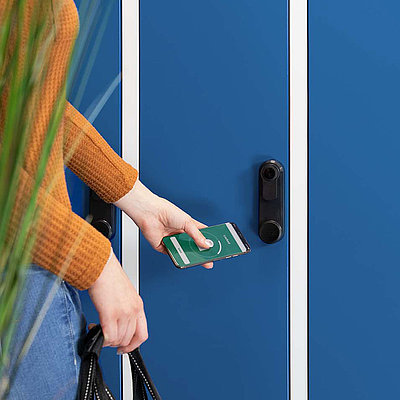 smartphone with lock screen is held on locker